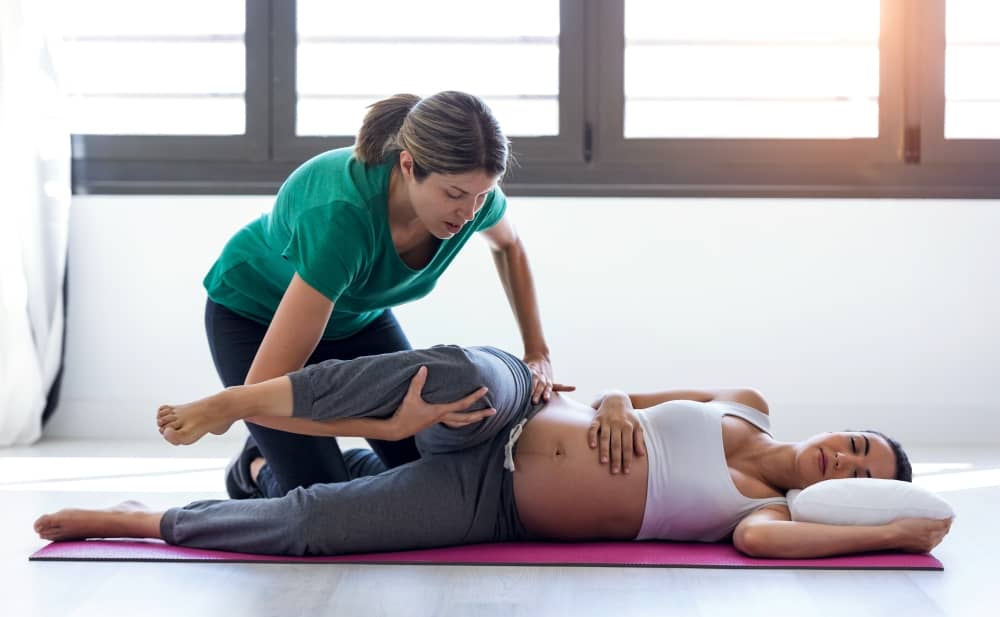 Pregnant woman, pilates session.