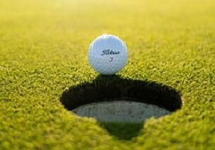 golf ball close to the hole