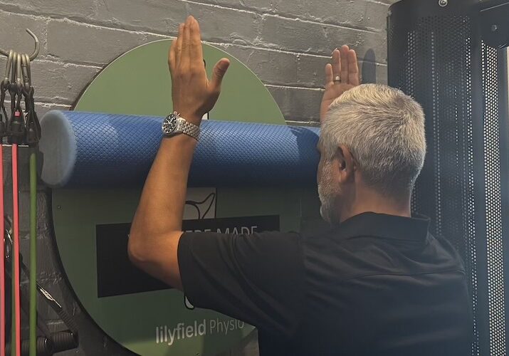 Kam doing one of the best physio exercises for shoulder pain, foam roller elevation