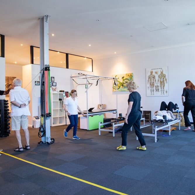 Team performing cardiac rehab in Sydney for several elderly patients