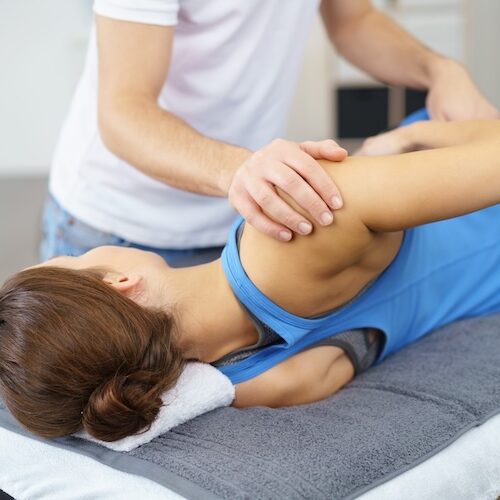 scoliosis-physio-perth Physio stretching a woman with scoliosis' back
